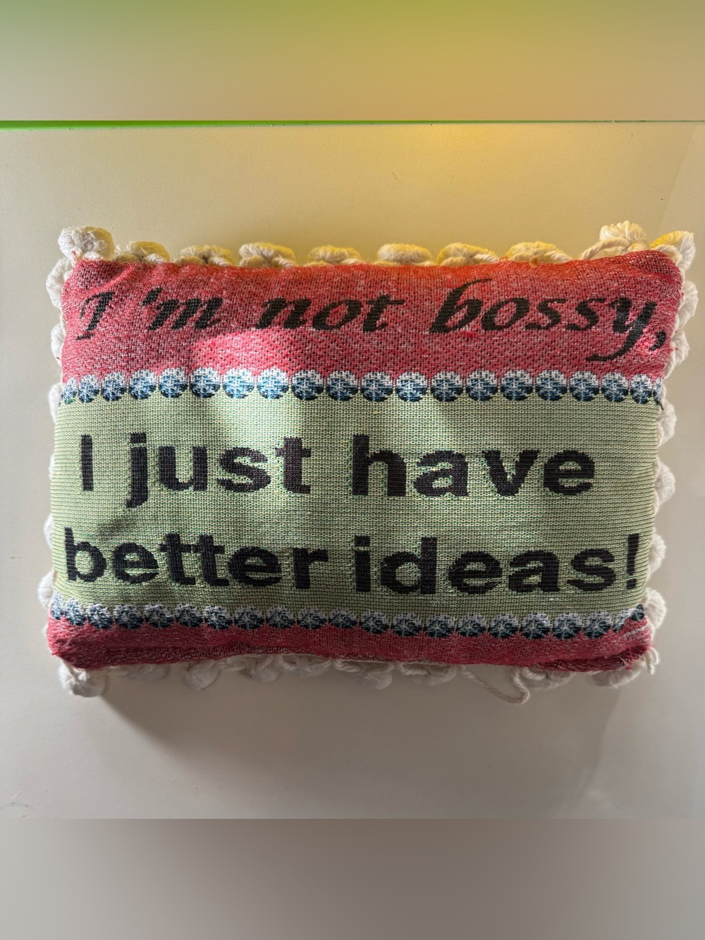 A needlepoint pillow with cheeky phrase "I'm not bossy,I just have better ideas”